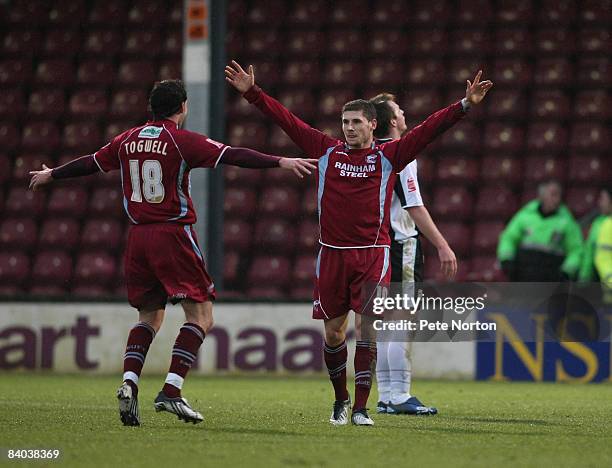 Gary Hooper of Scunthorpe United celebrates with team mate Sam Togwell after scoring his first and his sides second goal during the Coca Cola League...