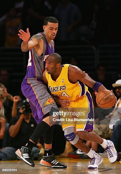 Kobe Bryant of the Los Angeles Lakers drives against Matt Barnes of the Phoenix Suns at at Staples Center on December 10, 2008 in Los Angeles,...