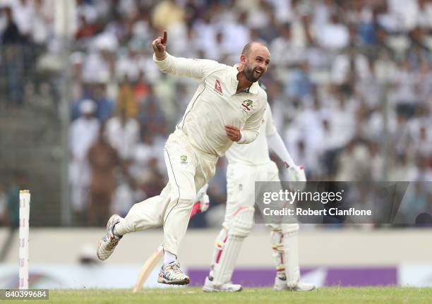 Nathan Lyon of Australia celebrates taking the wicket of Mushfiqur Rahim of Bangladesh during day three of the First Test match between Bangladesh...