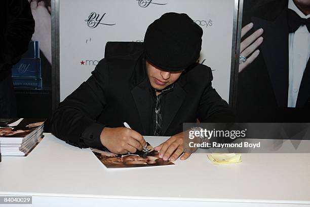 Latin rapper Daddy Yankee signs autographs while introducing his new fragrance, "DY", at Macy's on State Street in Chicago, Illinois on December 12,...