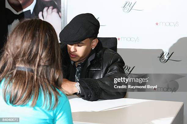 Latin rapper Daddy Yankee signs autographs while introducing his new fragrance, "DY", at Macy's on State Street in Chicago, Illinois on December 12,...