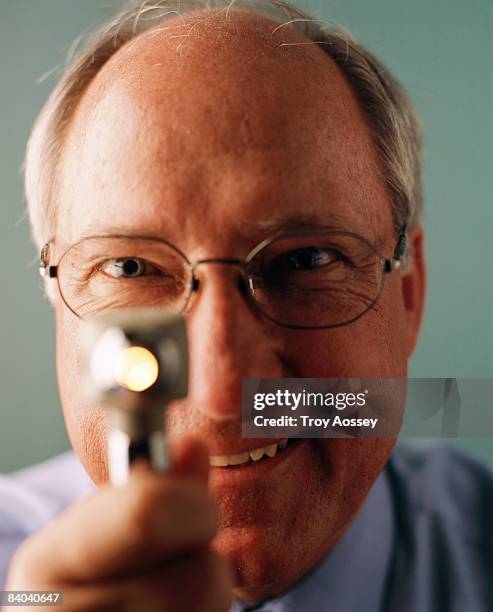 doctor holding medical instrument - otoscope bildbanksfoton och bilder