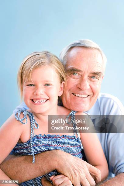 young girl  sitting on her grandfathers lap - troy bond stock pictures, royalty-free photos & images