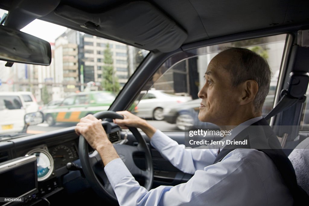 A taxi driver operating his vehicle