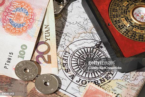 chinese coins and a feng shui compass on a map - 20 yuan note stock pictures, royalty-free photos & images