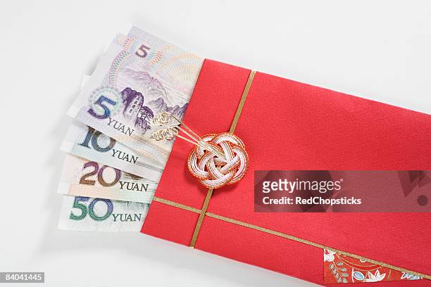 chinese currency in a red envelope - 20 yuan note stock pictures, royalty-free photos & images