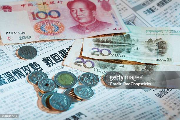 close-up of chinese currency on a newspaper - 20 yuan note stock pictures, royalty-free photos & images