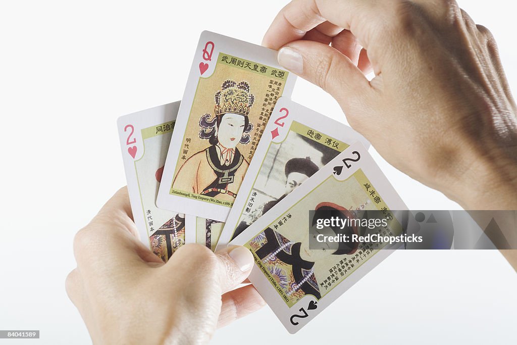 Close-up of a person's hands playing cards