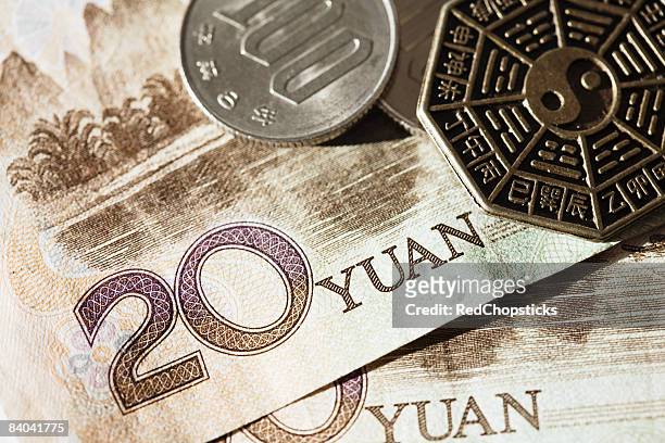 close-up of coins on chinese paper currency - 20 yuan note stock pictures, royalty-free photos & images