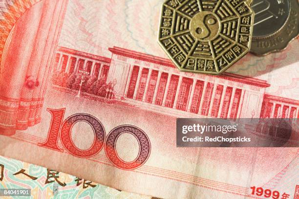 coins on a chinese yuan note with coins - 100 yuan note stock pictures, royalty-free photos & images