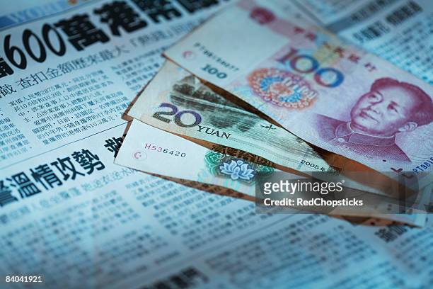 close-up of chinese currency on a newspaper - 20 yuan note stock pictures, royalty-free photos & images