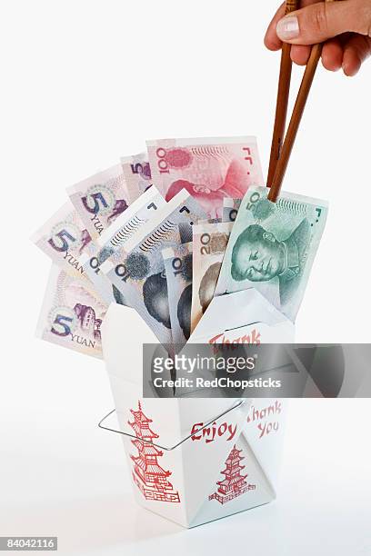 close-up of a person's hand picking chinese paper currency in a chinese takeout box - 20 yuan note stock pictures, royalty-free photos & images