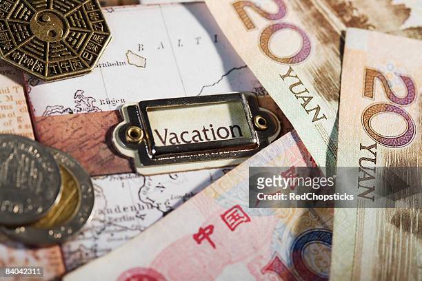 close-up of chinese currency on a map - 20 yuan note stock pictures, royalty-free photos & images