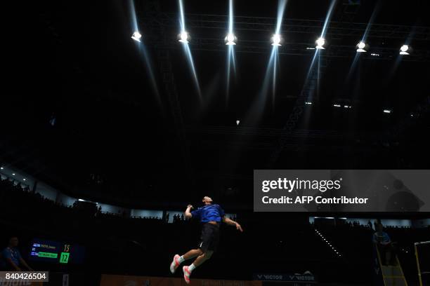 Khosit Phetpradab of Thailand hits a return against Jonatan Christie of Indonesia during the men's singles badminton final at the 29th Southeast...