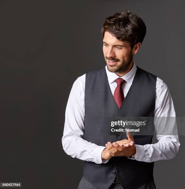 businessman with hands clasped looking away - waistcoat stock pictures, royalty-free photos & images