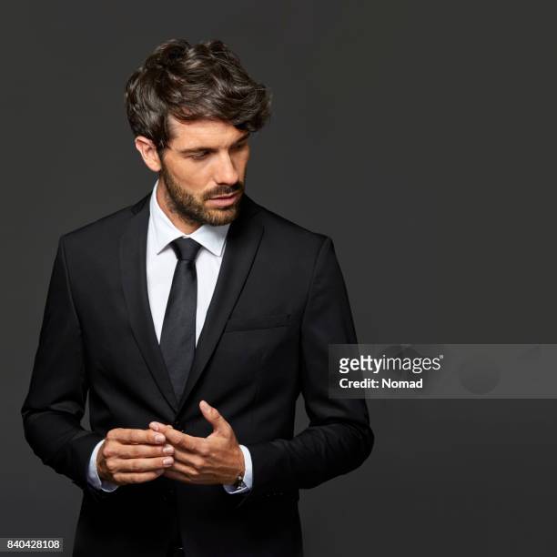smiling businessman with hands clasped - handsome people stock pictures, royalty-free photos & images