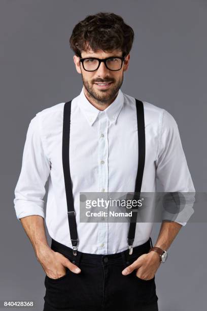 young businessman standing with hands in pockets - suspenders stock pictures, royalty-free photos & images