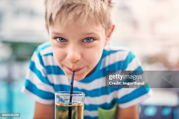 cute little boy drinking apple juice at hotel restaurant - apple juice stock pictures, royalty-free photos & images