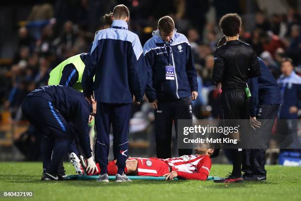 Bruno Fornaroli of Melbourne City is assisted onto a stretcher after sustaining an injury during the FFA Cup round of 16 match between Hakoah Sydney...