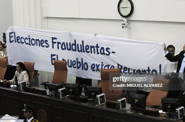 Opposition deputies hold a banner reading "Fraudulent election. The people claim recount as the President of the National Assembly of Nicaragua Rene...