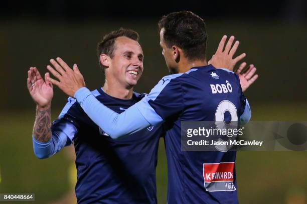 Bobo of Sydney is congratulated by Luke Wilkshire after scoring a goal during the round of 16 FFA Cup match between the Bankstown Berries and Sydney...