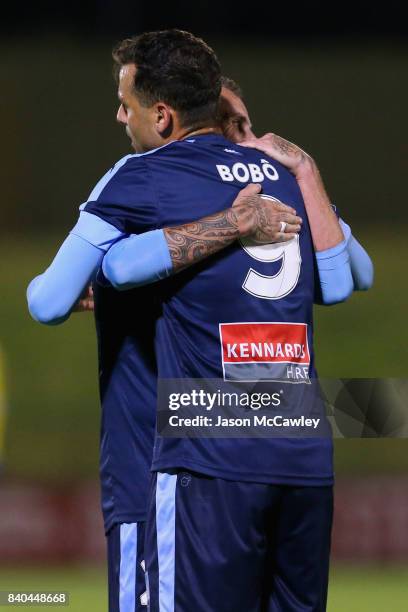 Bobo of Sydney is congratulated by Luke Wilkshire after scoring a goal during the round of 16 FFA Cup match between the Bankstown Berries and Sydney...