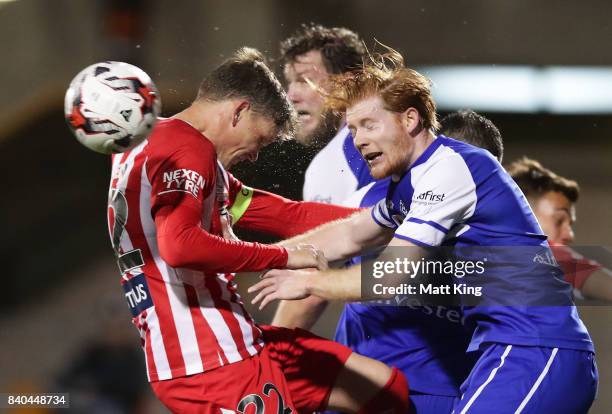 Michael Jakobsen of Melbourne City competes for the ball against Cameron Draper of Hakoah during the FFA Cup round of 16 match between Hakoah Sydney...