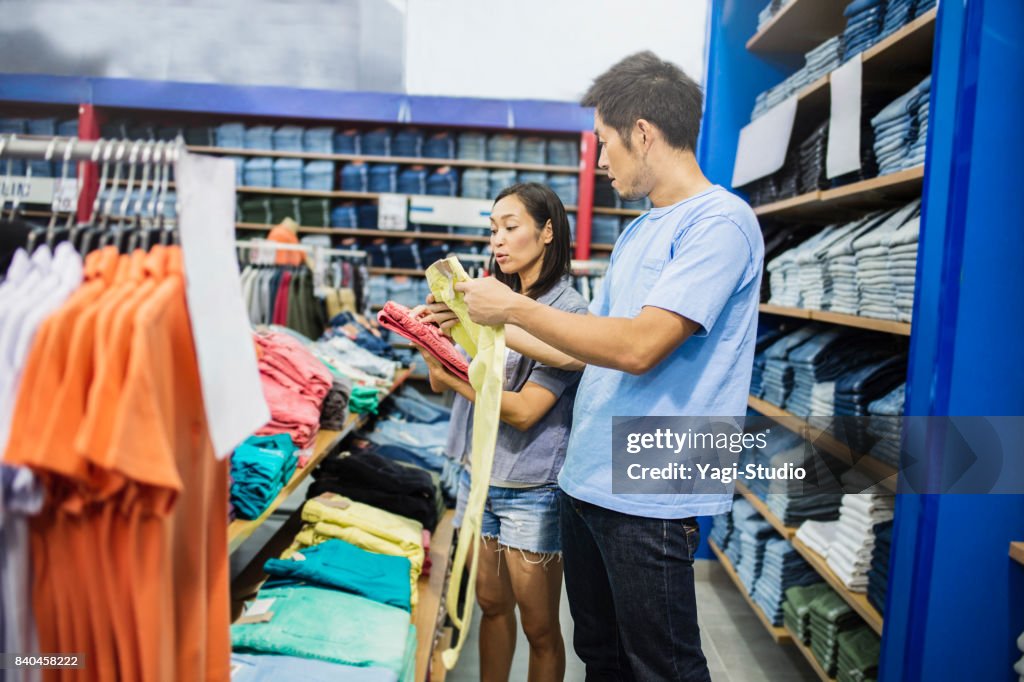 Mid adult couple choosing clothes
