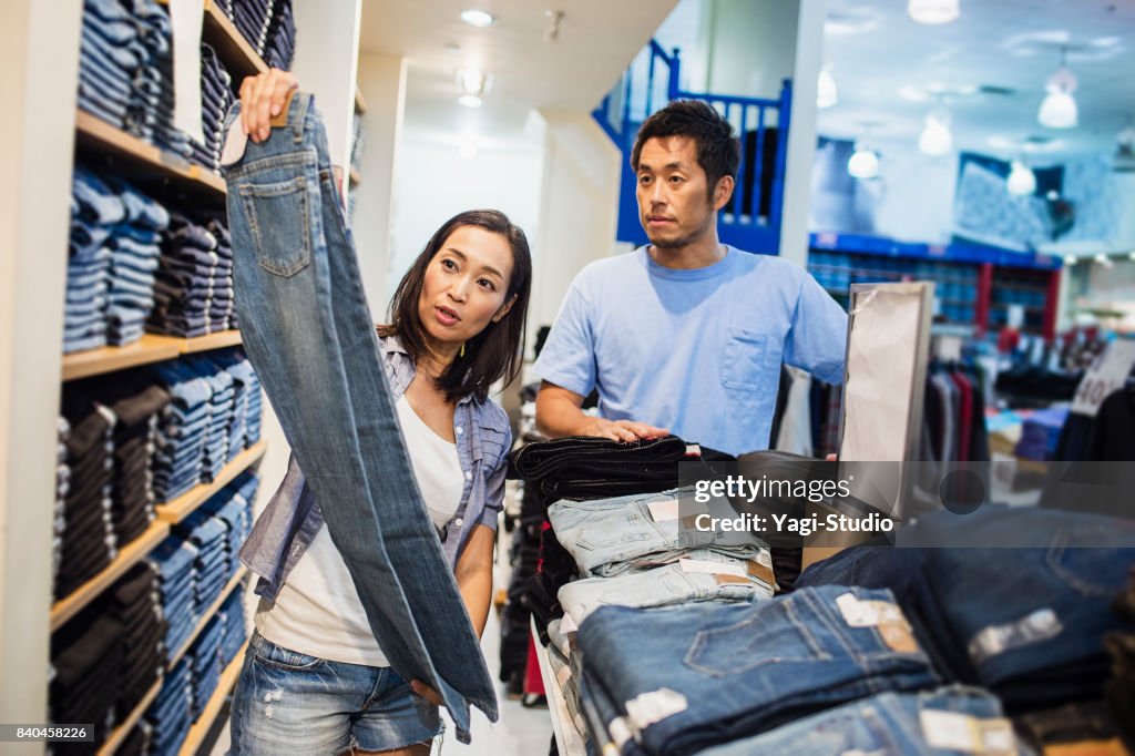 Mid adult couple choosing clothes
