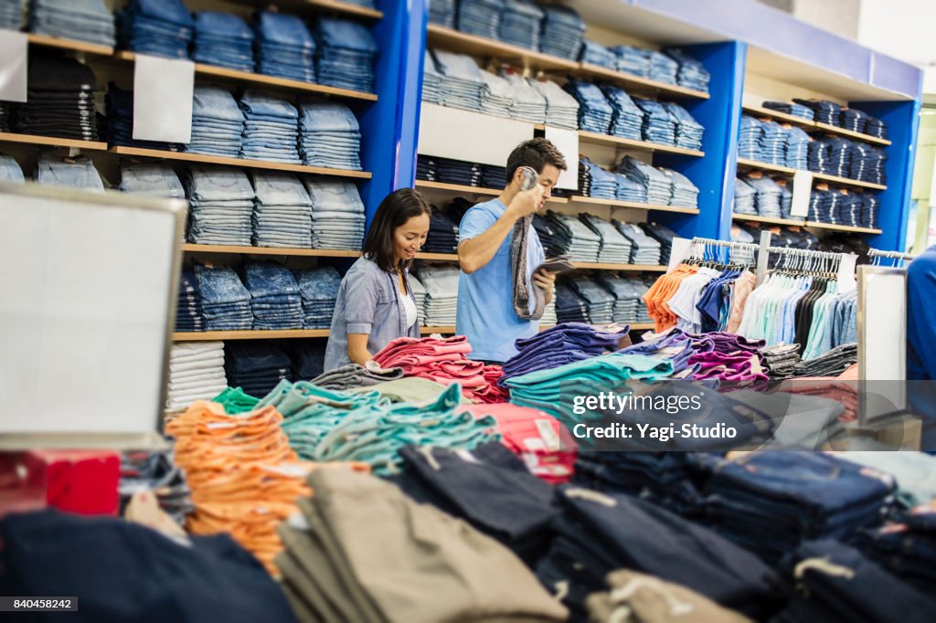 Mid adult couple choosing clothes