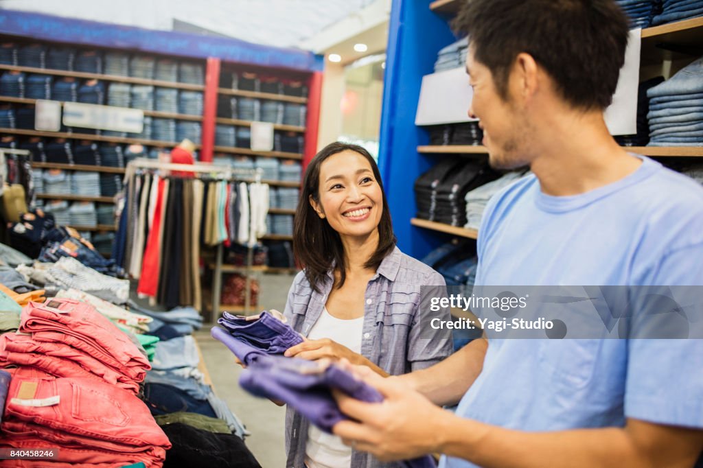 Mid adult couple choosing clothes