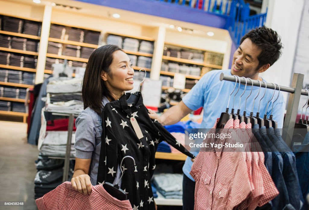 Mid adult couple choosing clothes