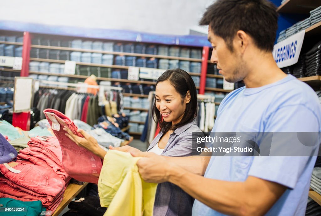 Mid adult couple choosing clothes