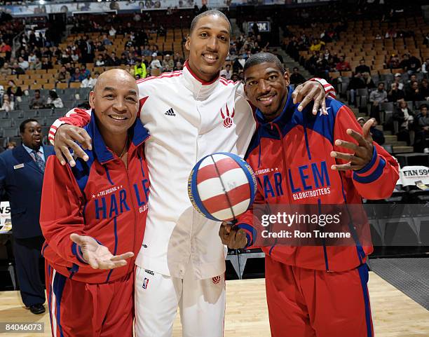 Jamario Moon of the Toronto Raptors poses with Curly Neal and Buckets Blakes of the Harlem Globetrotters before his game versus the New Jersey Nets...