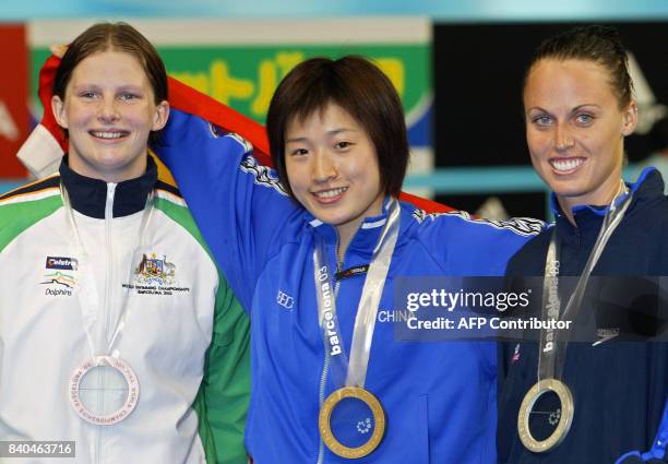 Chinese gold medalist Xuejuan Luo swims in front of Australian bronze medalist Leisel Jones and US silver medalist Amanda Beard after the 100m...