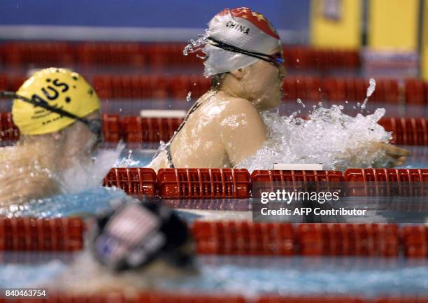 Chinese gold medalist Xuejuan Luo swims in front of Australian bronze medalist Leisel Jones and US silver medalist Amanda Beard during the 100m...