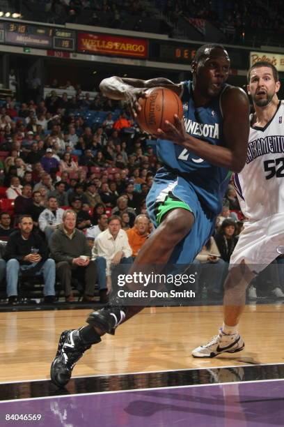 Al Jefferson of the Minnesota Timberwolves takes the ball to the basket against Brad Miller of the Sacramento Kings on December 15, 2008 at ARCO...