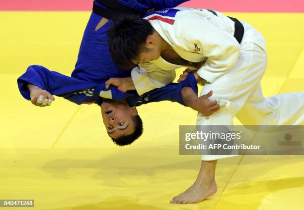 Japan's Hifumi Abe competes with Ukraine's Georgii Zantaraia during their match in the mens -66kg category at the World Judo Championships in...