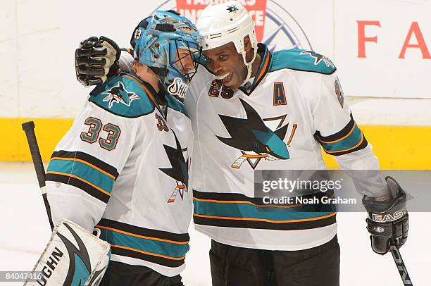 Mike Grier of the San Jose Sharks congratulates teammate goalie Brian Boucher for a 3-2 win in a shootout against the Los Angeles Kings during the...