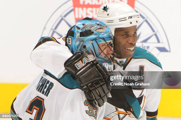 Mike Grier of the San Jose Sharks congratulates teammate goalie Brian Boucher for a 3-2 win in a shootout against the Los Angeles Kings during the...