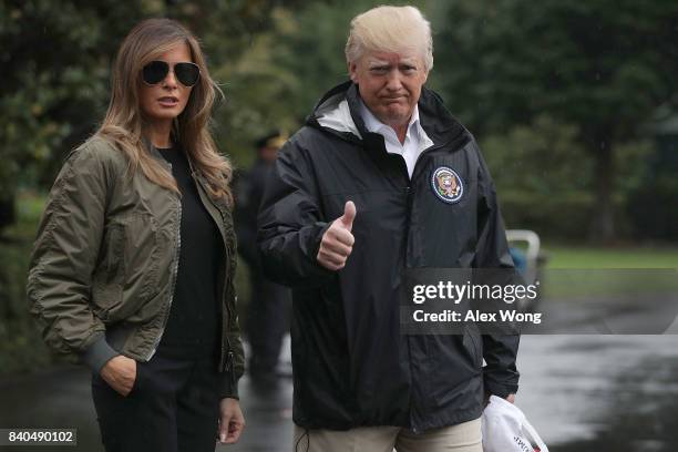 President Donald Trump gives a thumbs up as he walks with first lady Melania Trump prior to their Marine One departure from the White House August...