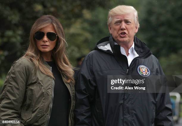 President Donald Trump speaks to members of the media briefly as first lady Melania Trump looks on prior to their Marine One departure from the White...