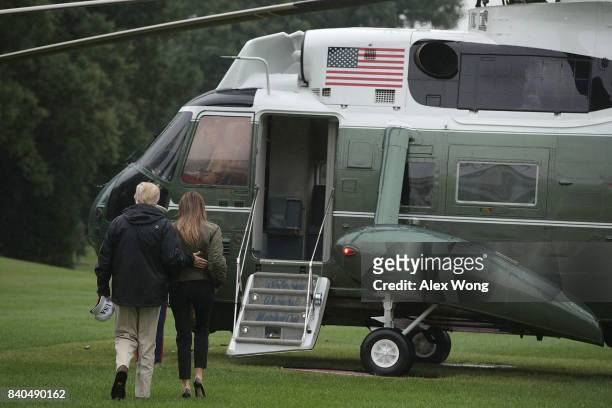 President Donald Trump and first lady Melania Trump walk on the South Lawn towards the Marine One prior to their departure from the White House...