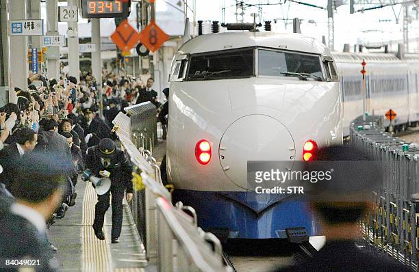 Last train of the first generation shinkansen bullet train leaves Shin-Osaka station in western Japan for its last run on December 14, 2008....