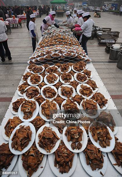 Chefs prepare dishes for residents of a village prior to a dinner held to mark the 30th anniversary of China's reform initiative on December 16, 2008...