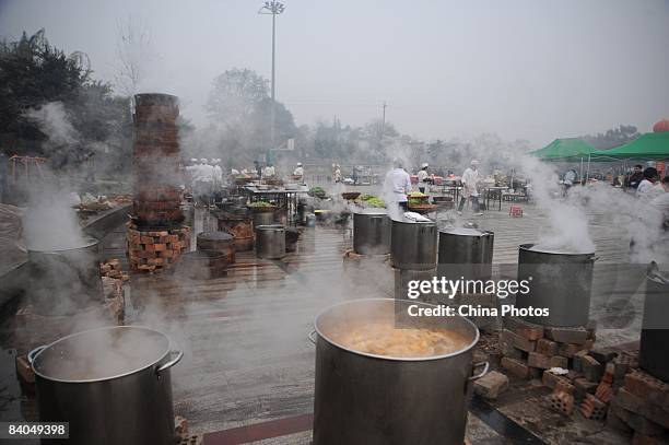 Chefs prepare dishes for residents of a village prior to a dinner held to mark the 30th anniversary of China's reform initiative on December 16, 2008...