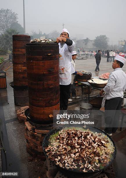 Chefs prepare dishes for residents of a village prior to a dinner held to mark the 30th anniversary of China's reform initiative on December 16, 2008...