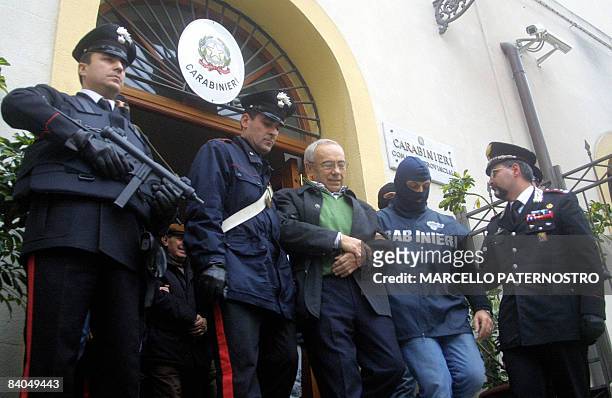 Italian police escort suspect Benedetto Capizzi from their headquarters in Palermo on December 16, 2008. Italian police carried out a "historic"...