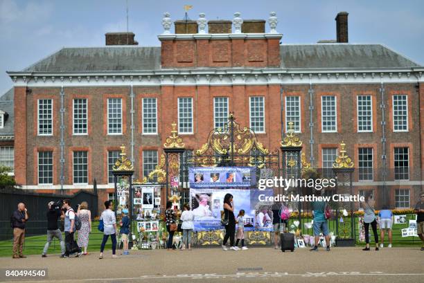 People commemorate the 20th anniversary of Princess Diana by laying flowers and tributes at Kensington Palace on August 29, 2017 in London, England....