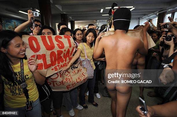 Nude members of the Alpha Phi Omega fraternity make their way through a crowd of students during the traditional "Oblation Run" at the country's...